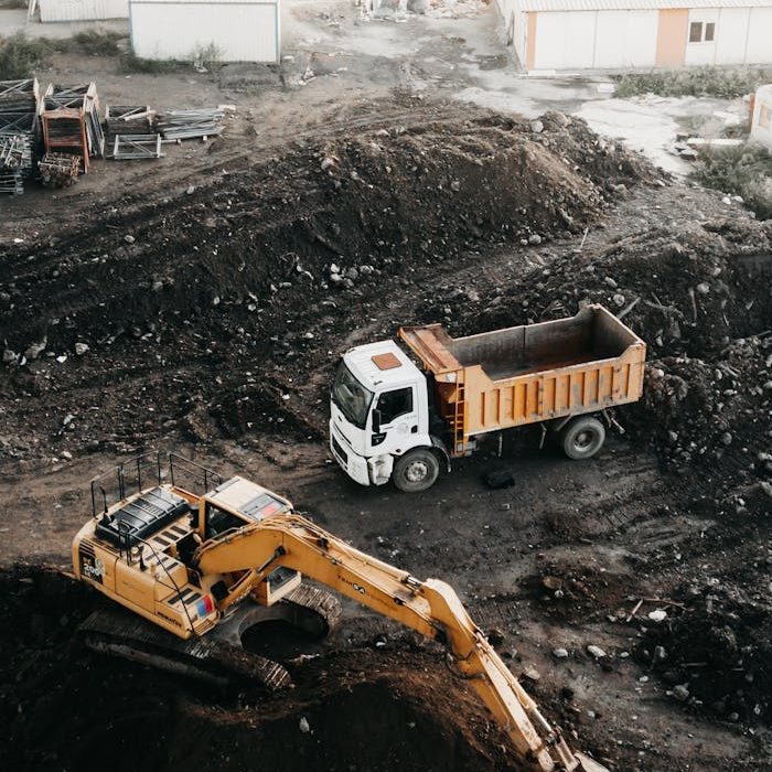 A high angle view of a construction site in Istanbul featuring an excavator and a truck.
